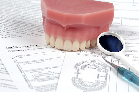 dental tools and false teeth used at Ellinwood Dental Care