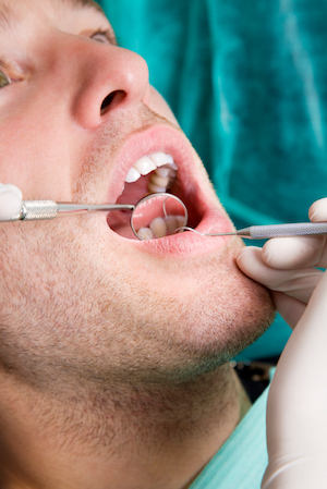 Male patient during a preventative dentistry and gum disease therapy treatment at Ellinwood Dental Care in Fort Wayne, IN