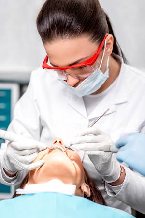 dental hygienist performing preventative dentistry services on a female patient at Ellinwood Dental Care in Fort Wayne IN